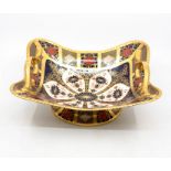 A Royal Crown Derby 1128 Imari pattern twin handled pedestal basket, in the solid gold band first