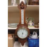 An early 20th century Aneroid Barometer and thermometer, together with a figural barometer in the