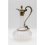 An Edwardian cut glass and silver plate mounted claret jug, bulbous shape with scrolling shape,