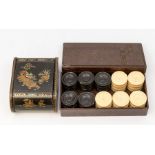 A vintage ebonised and ivorine turned draughts set together with a Japanese lacquered box, decorated