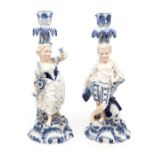 Pair of late 19th century German mantle candle sticks in the shape of a boy and a girl.