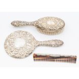 A three piece silver dressing table brush set, comprising of a brush, comb and mirror. Birmingham