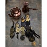 A collection of brassware to include: various early 20th Century horse brasses mounted on leather