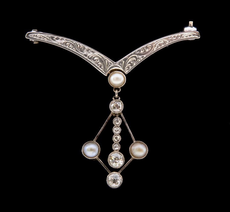 An Edwardian diamond and pearl set platinum and gold brooch, comprising an engraved wish bone shaped