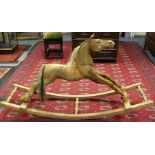 Rocking Horse: A mid-20th century wooden rocking horse, unpainted, upon curved, planked base with