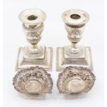 A group of silver to include: a pair of Edwardian Neo-Classical style silver dwarf candlesticks,