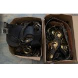 A collection of 19th & 20th horse brasses (swingers) loose and mounted on leather straps, bridle