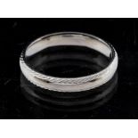 A platinum wedding band with diamond cut edges, court shaped, width approx 3mm, size N1/2, weight