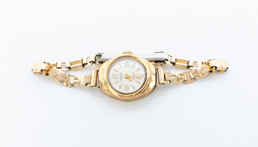 A Sekonda ladies 9ct gold wristwatch, round champagne dial with applied gold tone baton markers,