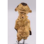 Late 19th century to early 20th century chocolate punch figure on stand with gilt gold foil in
