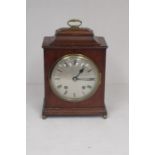 Early 20th century English made mahogany bracket clock with round dial and Roman numerals.