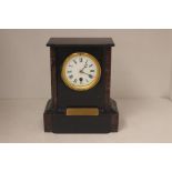 A Victorian slate and marble mantel clock.