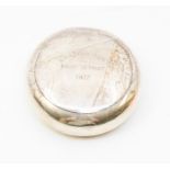 a silver tobacco container, circular form with concealed lid, inscribed Crafton Hunt point to