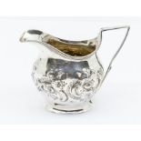 A George III silver helmet shaped cream jug, later chased with floral decoration, London, 1805, 2.93