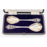 A pair of Arts & Crafts serving spoons, openwork engraved terminals with foliate decoration,