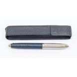 A Louis Vuitton Doc blue leather and rhodium rollerball pen, highlighted with 25 solid gold staples,