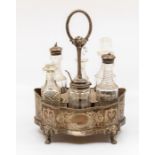 A Victorian seven piece cruet and silver mounted stand, the silver stand shaped oval with beaded rim