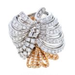 A diamond and 18ct white and rose gold dress ring, comprising white gold open fan like rows of grain