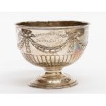 A Victorian silver rose bowl, chased with ribbon tied swags, gadroon section on raised foot,