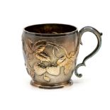 A Victorian silver gilt barrel shaped Christening mug, the body chased with strawberries and leaves,