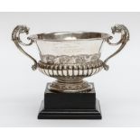 A Victorian silver two handled cup, the handles with lion's head terminals, with chased foliate