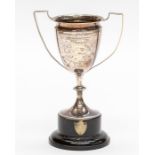 A George V silver two handled trophy, with presentation inscription reads: NEWQUAY & DISTRICT