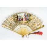 A late Victorian hand-painted and mother-of-pearl fan, painted with a young female at a well, signed