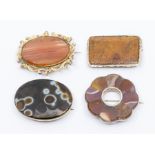 A collection of four Victorian/early 20th century hard stone brooches, to a Victorian oval brooch