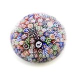 A Baccarat millefiori paperweight, set with multiple canes including four Gridel silhouettes of a