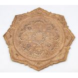 An Islamic copper tray, pierced with moons and flowers, 37cm diameter.