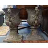 A pair of Italianate style campana shaped large bronzed garden two handled urns, lion handles,