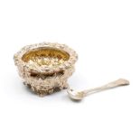 A George IV silver-gilt large circular salt, border and body chased with flowers and foliage, on