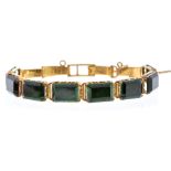 An emerald and unmarked gold bracelet, comprising rectangular shaped articulated links of emerald,
