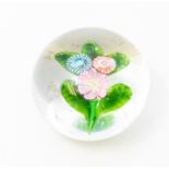 A 19th century Baccarat style floral paperweight, set with blue, orange and pink flowers, on green