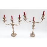 A pair of silver plated on copper three branch Candelabra, the leafage cast sconces on reeded