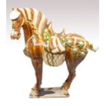 A large Chinese Tang style sancai glazed pottery horse, 20th century, the animal standing four