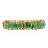 A Chinese jade and unmarked gold bracelet, comprising crescent shaped articulated links of jade,