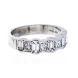 A diamond half set eternity 18ct white gold ring, comprising alternate emerald cut and princess