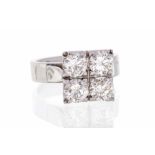 A diamond and 18k white gold ring, comprising four grain set round brilliant cut diamonds in