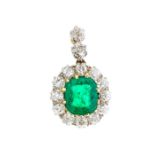 An emerald and diamond 18ct gold pendant, with claw set central emerald-cut emerald approx 7 x