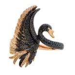 A black and white diamond 18ct rose gold double finger ring in the form of a black swan, the body