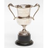 A George V silver two handled trophy, facet lower section, presentation inscription reads: