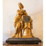 A large French clock with a Gilded lady leaning on a pillar. Set on a slate plinth. Two train French