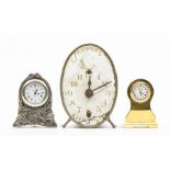 A "Skippers" alarm clock, the enamel dial inscribed "Skippers, keep smiling", a brass miniature