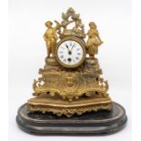 A late 19th century gilded spelter mantel clock, figural body, fitted with a white enamelled dial,