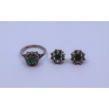 An 18ct white gold emerald and diamond cluster ring and a pair of emerald and white stone cluster