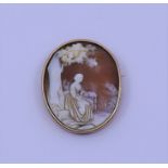 A cameo brooch, in yellow gold mount, depicting figure under tree, approx 13g