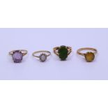 A collection of four gold rings various stones set