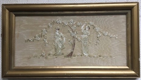 An embroidery on silk of two women picking blossom beneath the tree, pale colour embroidery threads,