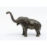 An Austrian cold painted bronze model of an elephant with trunk raised, the base marked "Geschutzt",